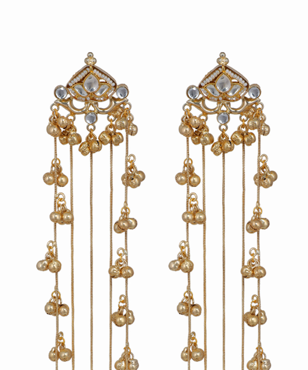 Gold earrings with pearl-like beads on a white background