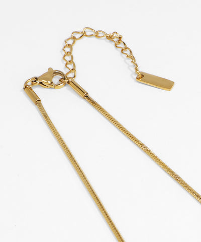 Gold chain necklace on a white background