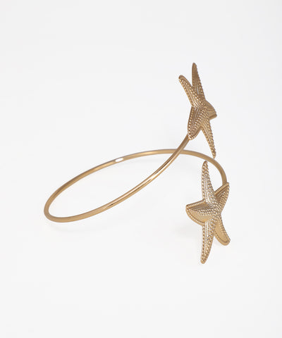 Gold starfish bracelet on a white background