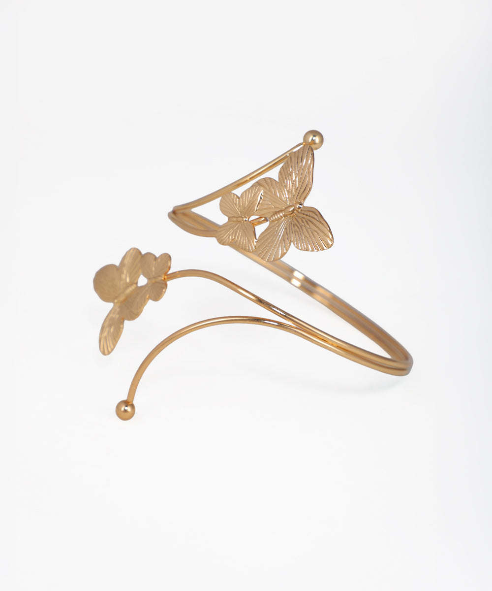 Gold bracelet with butterfly designs on a white background