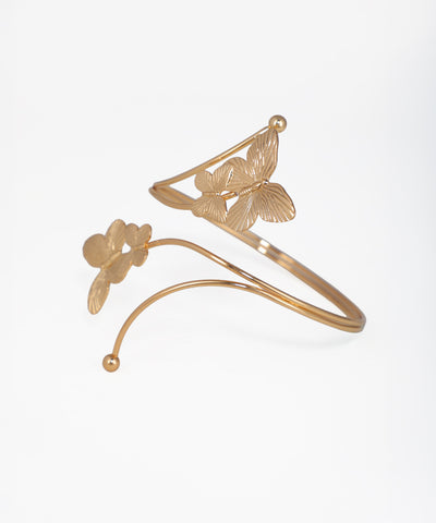 Gold bracelet with butterfly designs on a white background