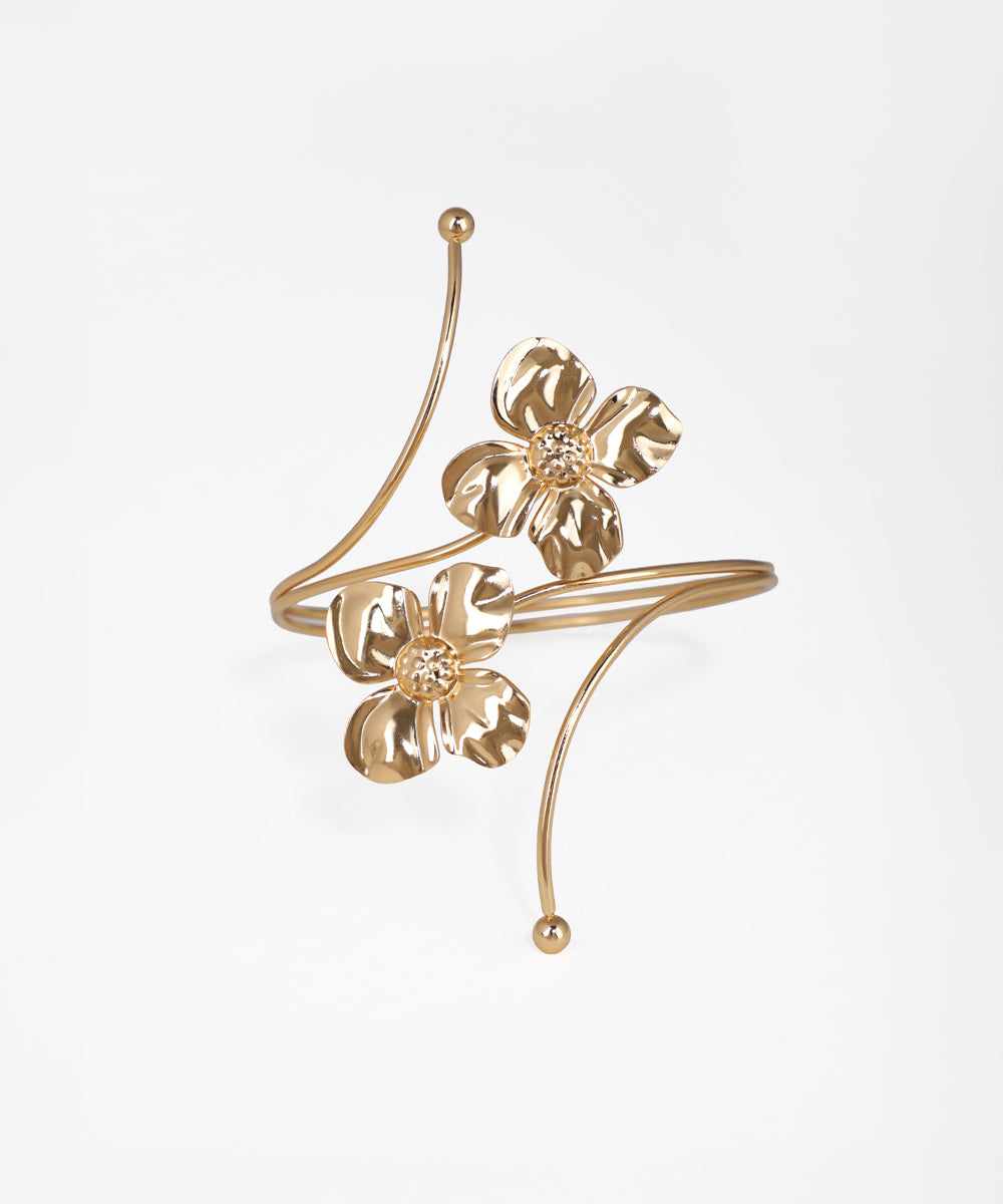Gold floral ear cuff on a white background