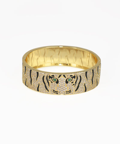 Gold bracelet with tiger design on a white background