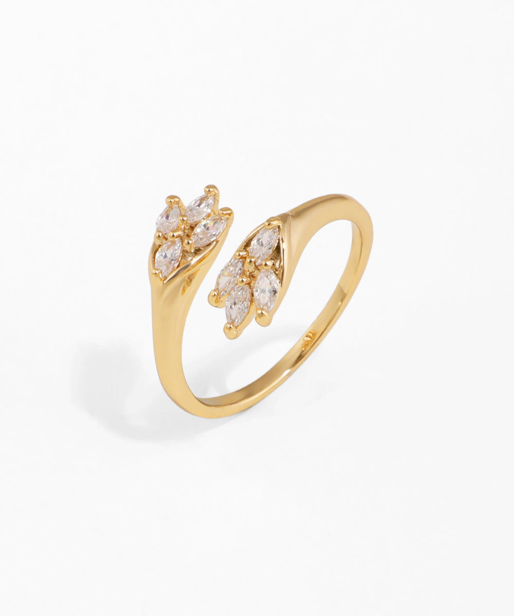 Gold ring with diamond accents on a white background