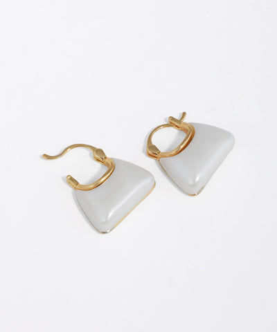 Pair of triangle-shaped bag shaped earrings with gold accents on a white background