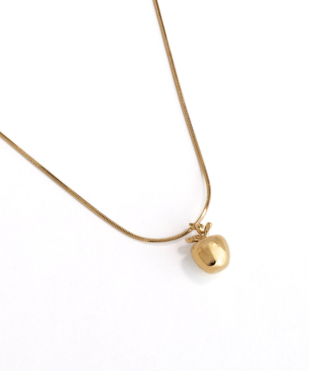 Gold necklace with a heart-shaped pendant on a white background