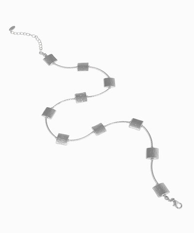 Silver bracelet with square links on a white background