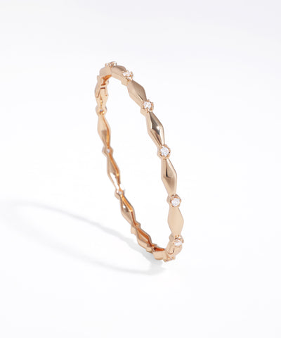 Rose gold bracelet with diamond accents on a white background