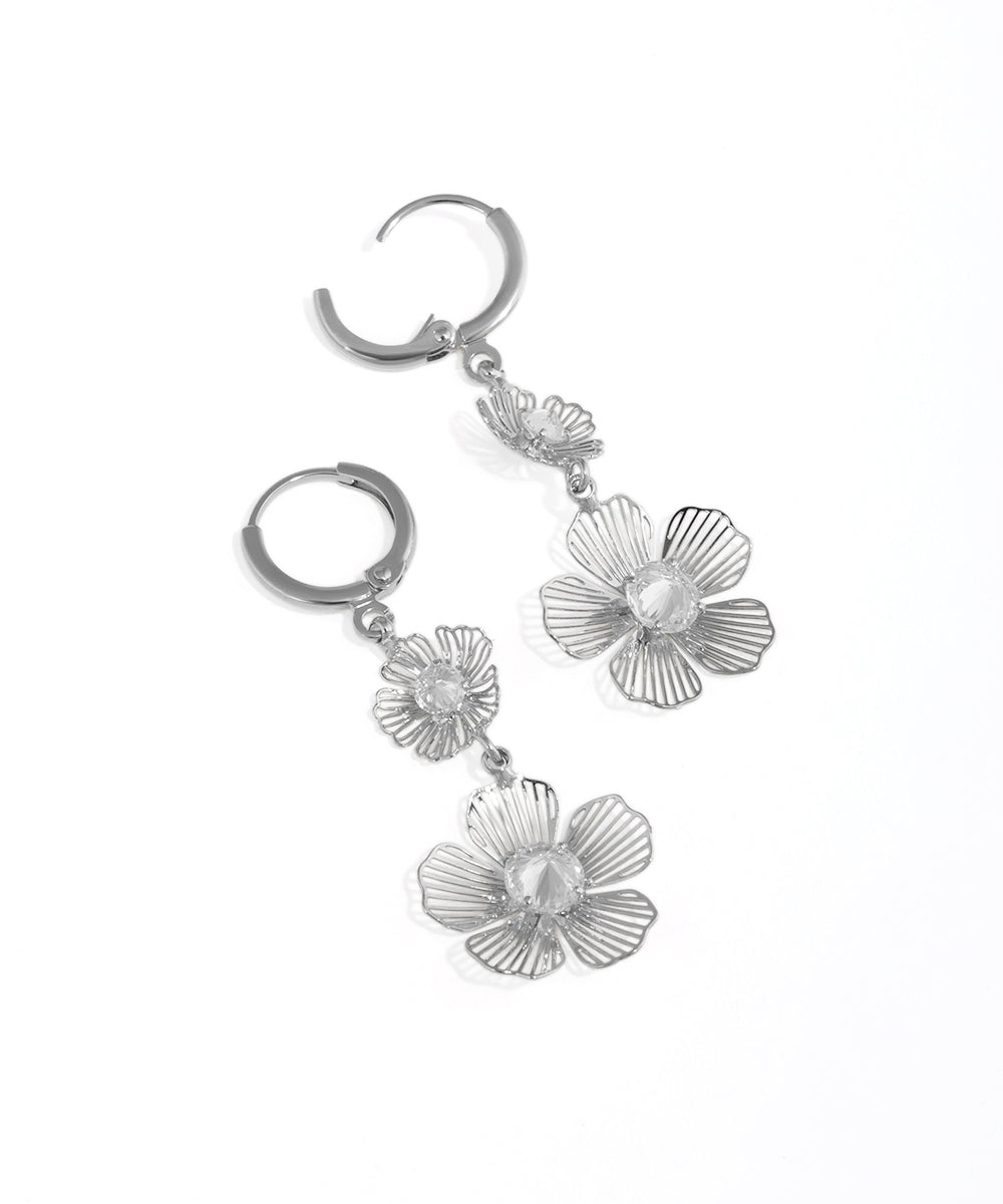 Silver floral earrings on a white background