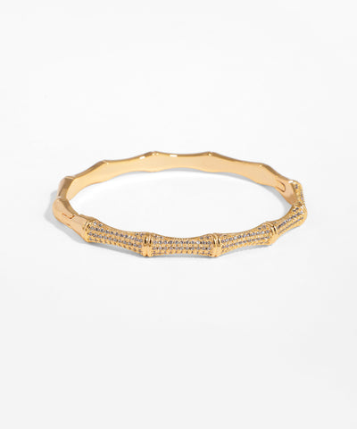 Gold bracelet with diamond accents on a white background