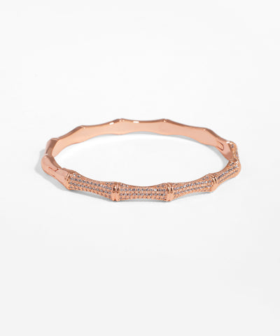 Rose gold bracelet with small diamonds on a white background