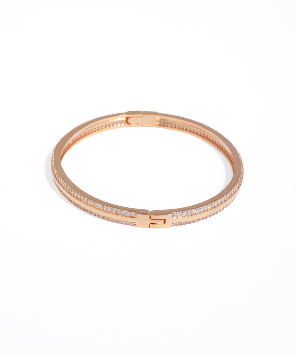 Rose gold bracelet with clear stones on a white background