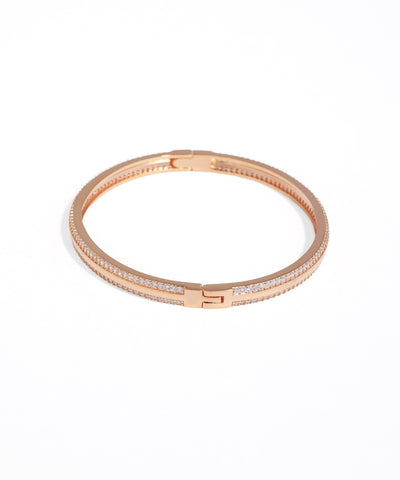 Rose gold bracelet with clear stones on a white background