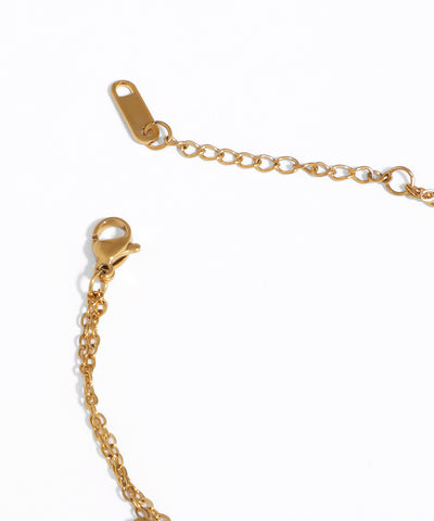 Gold bracelet with clasp on a white background