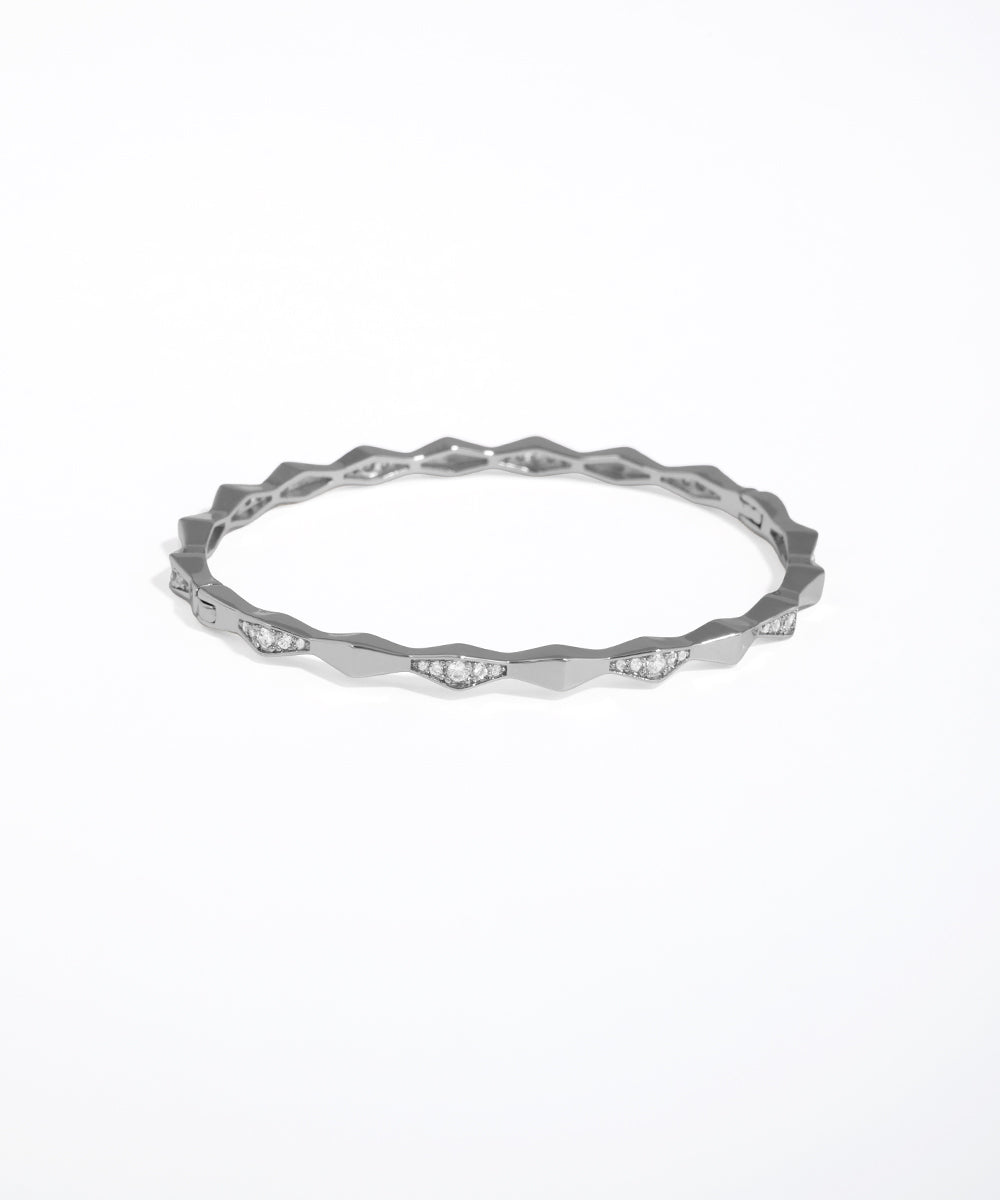 Silver ring with a textured band on a white background