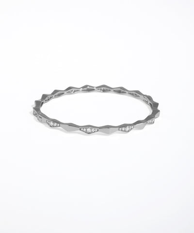Silver ring with a textured band on a white background