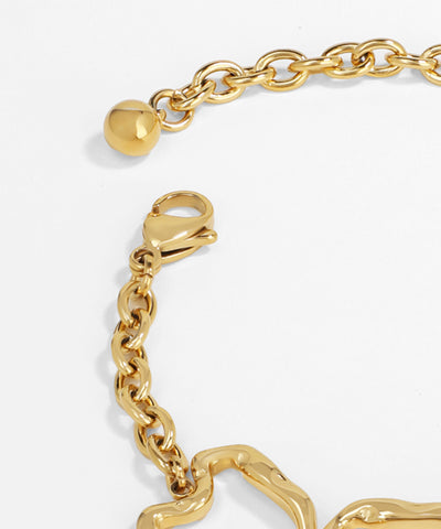 Gold chain bracelet with heart-shaped clasp on a white background