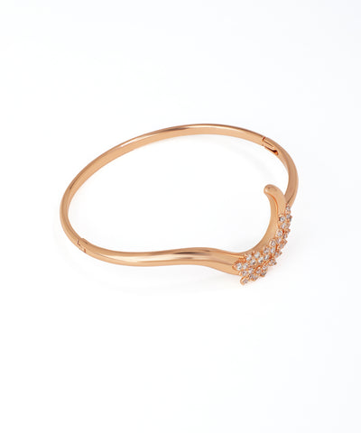 Rose gold bracelet with small diamonds on a white background