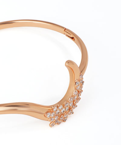 Rose gold bracelet with diamond accents on a white background