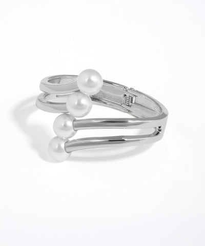 Silver bracelet with three pearls on a white background