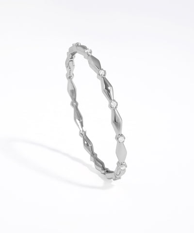 Silver bracelet with a subtle design on a white background