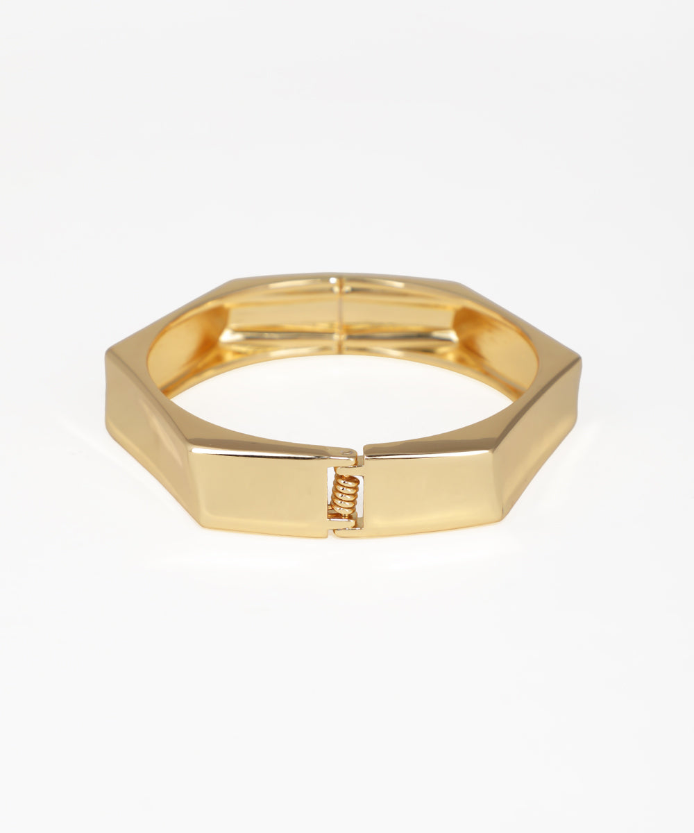 Gold hexagonal ring on a white background