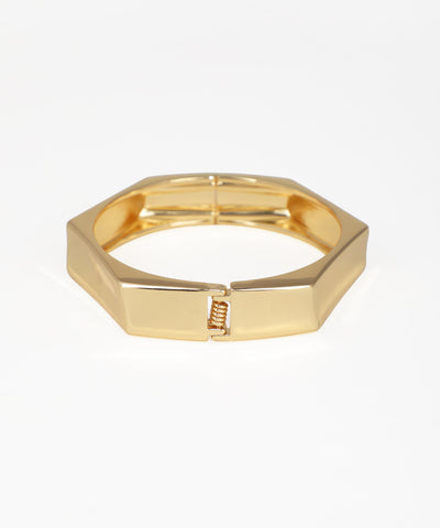 Gold hexagonal ring on a white background