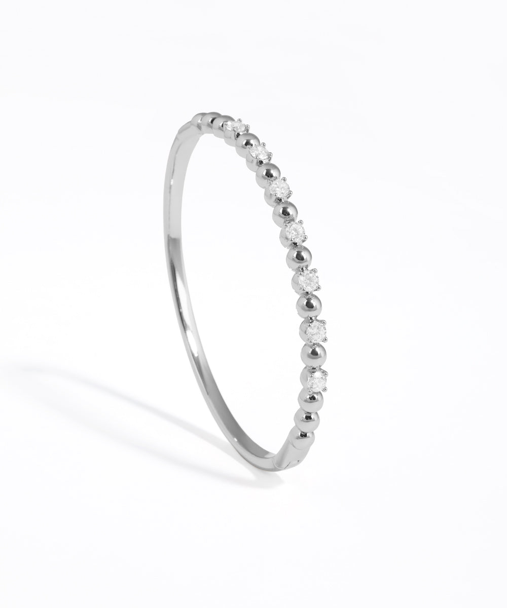 Silver ring with small stones on a white background