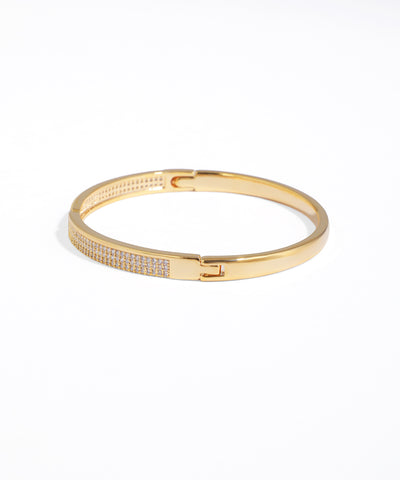 Gold bracelet with small stones on a white background