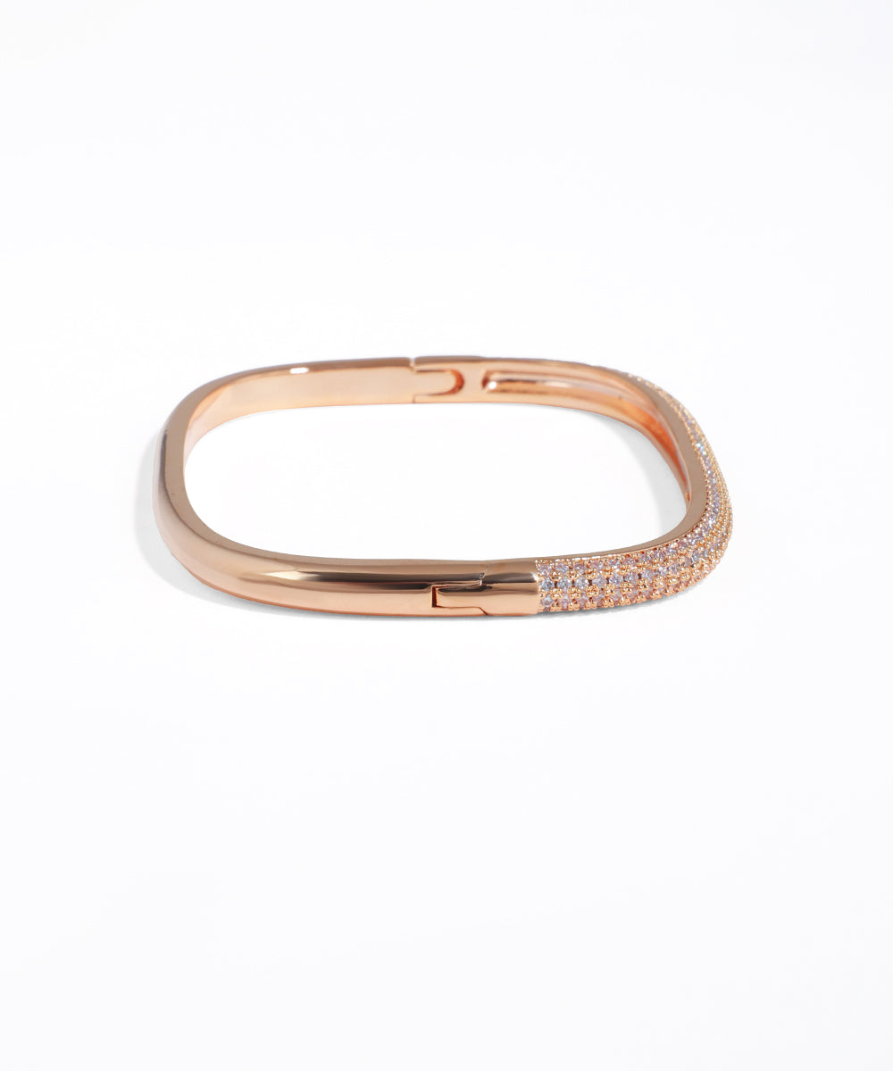 Rose gold bracelet with clear stones on a white background