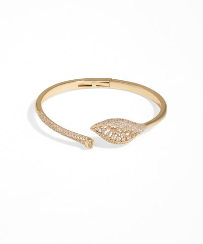 Gold bracelet with leaf design on a white background