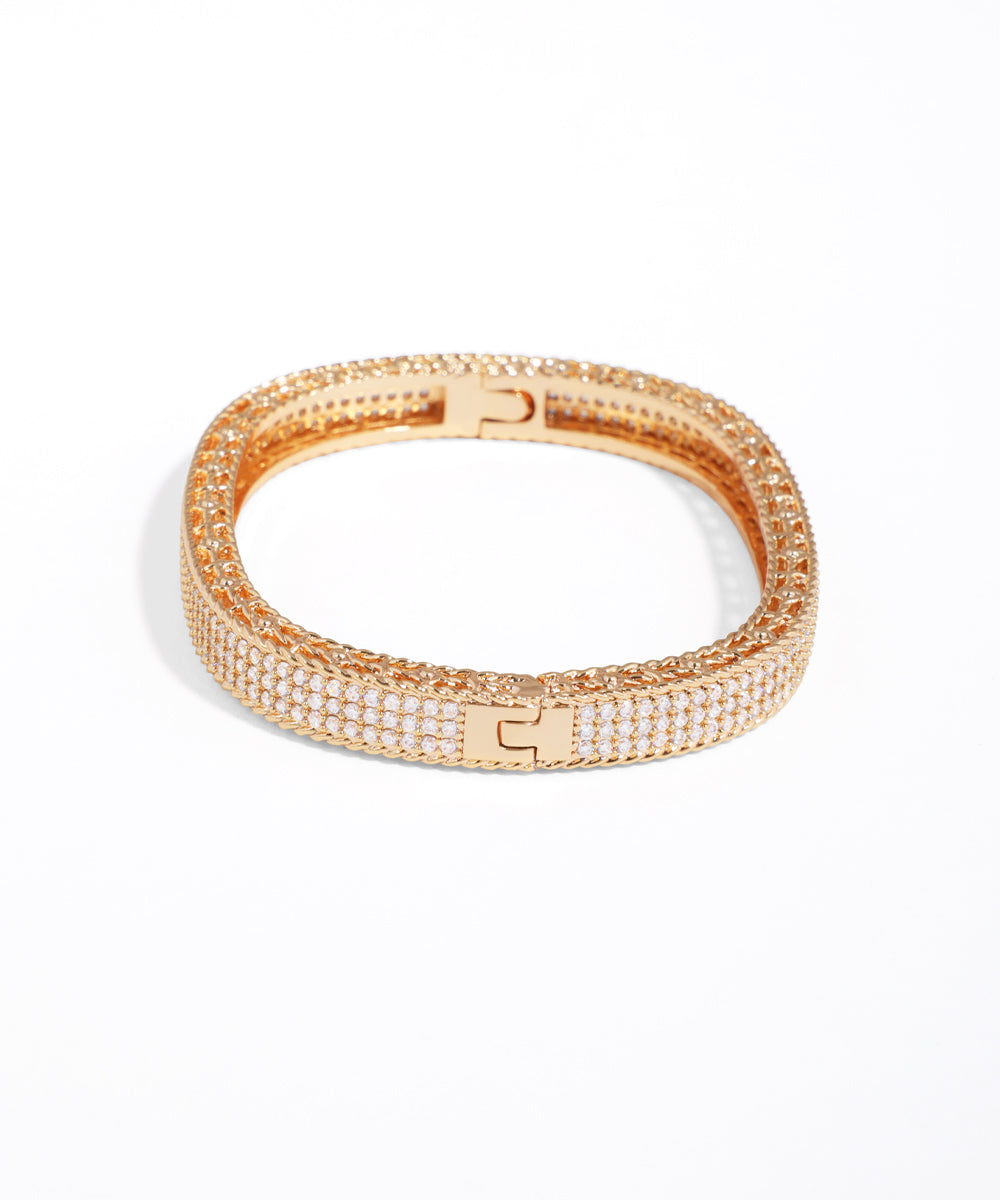 Rose gold bracelet with clear stones on a white background
