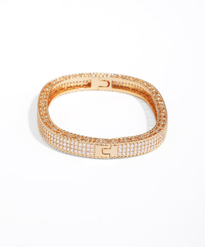 Rose gold bracelet with clear stones on a white background