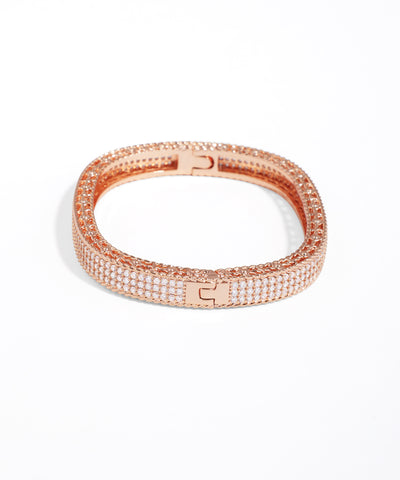 Rose gold bracelet with clear stones on a white background