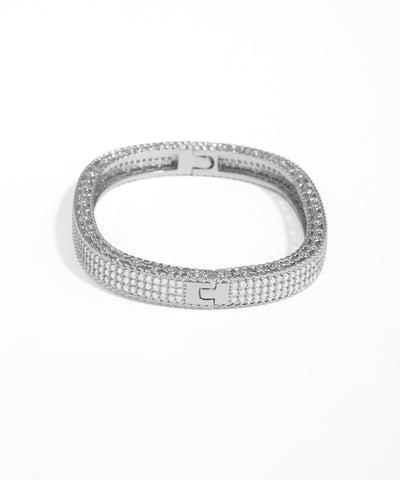 Silver bracelet with clear stones on a white background