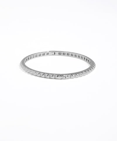 Silver ring with a textured band on a white background