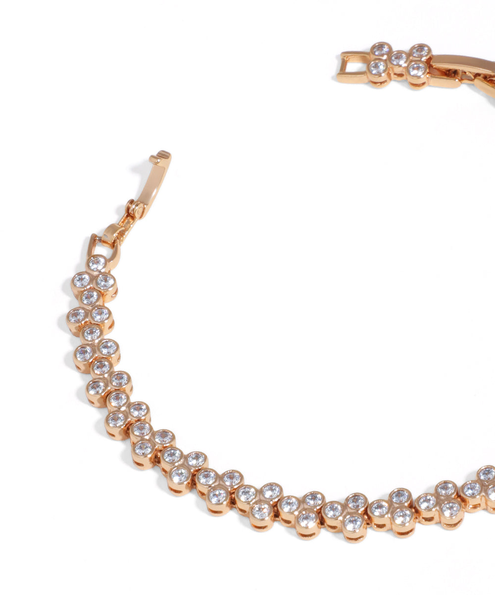 Rose gold bracelet with clear stones on a white background