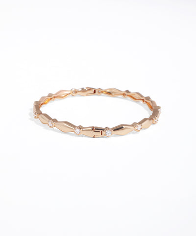 Rose gold bracelet with small diamonds on a white background