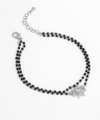 Black beaded bracelet with silver clasp on a white background