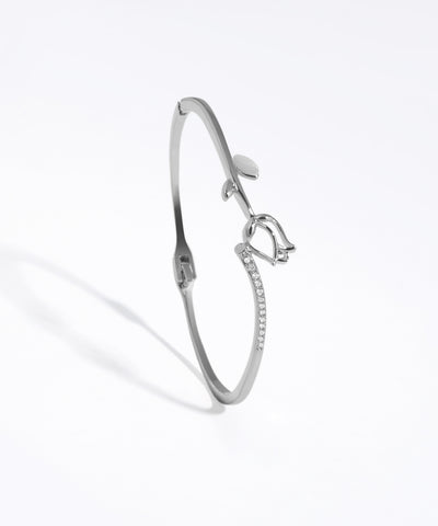 Silver bracelet with bow design on a white background