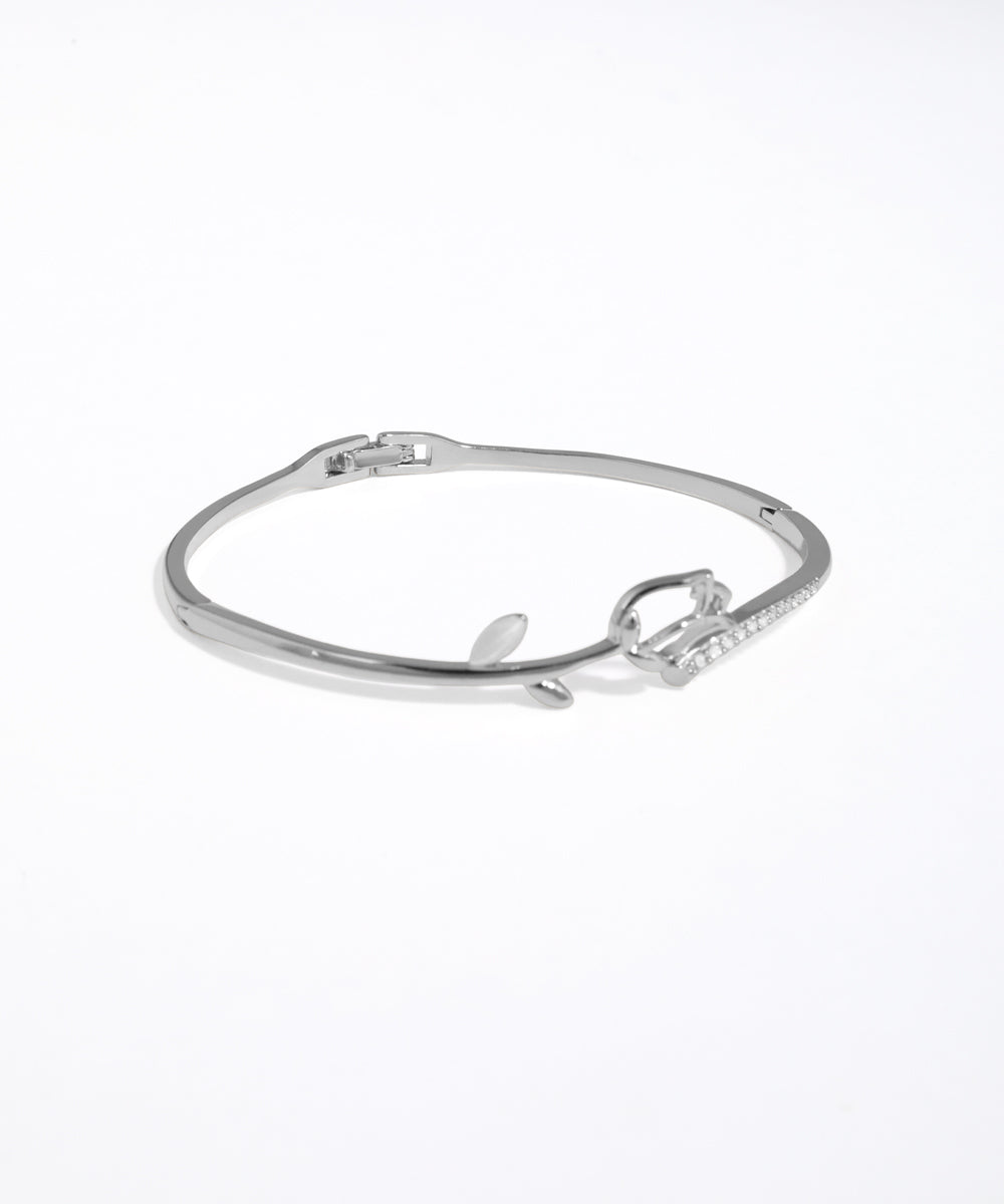 Silver bracelet with a bow design on a white background
