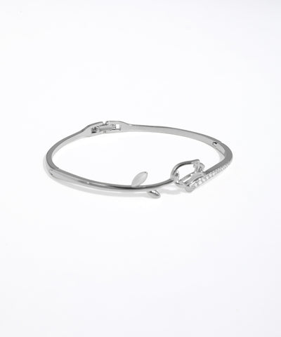 Silver bracelet with a bow design on a white background