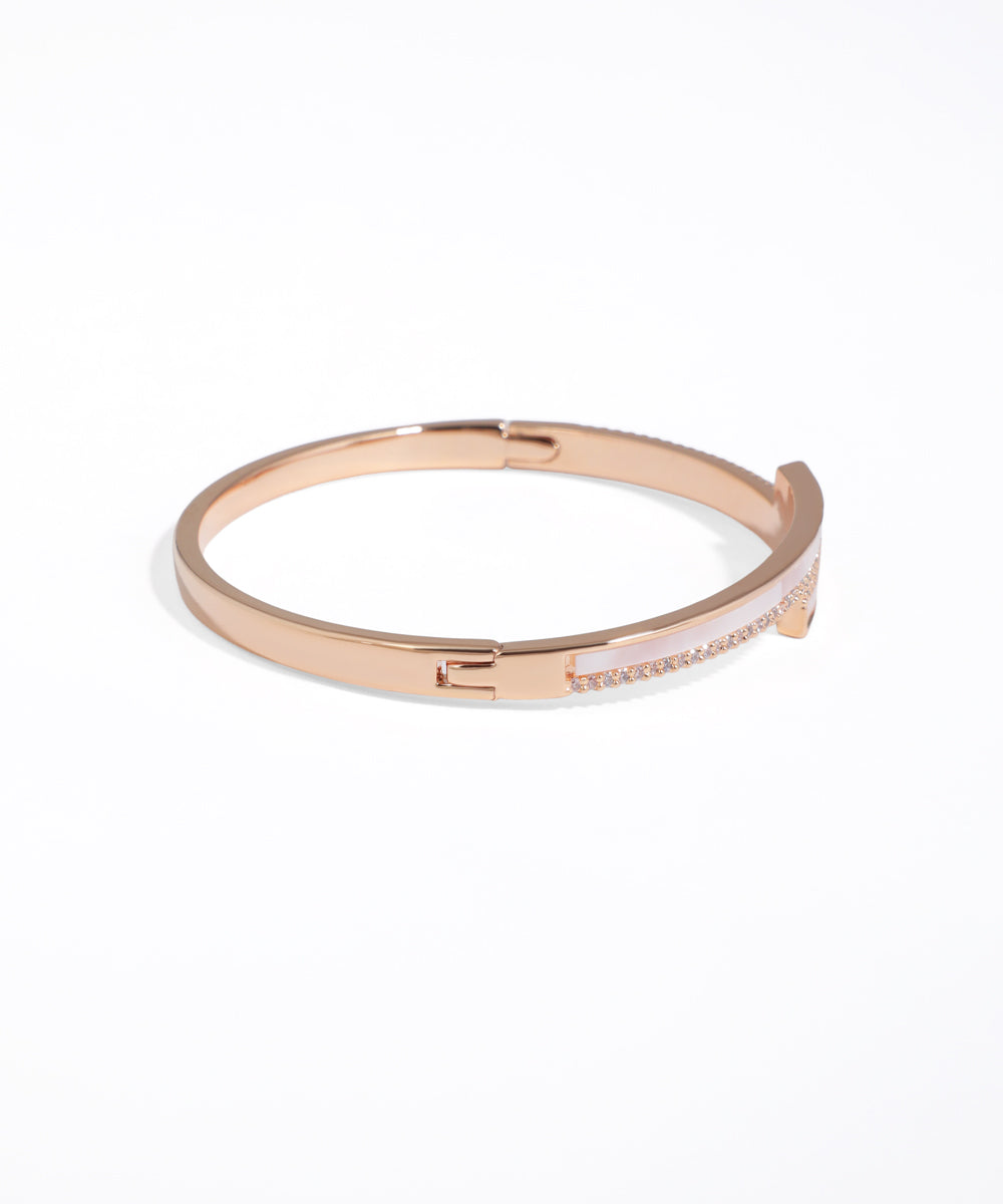 Rose gold bracelet with white interior on a white background
