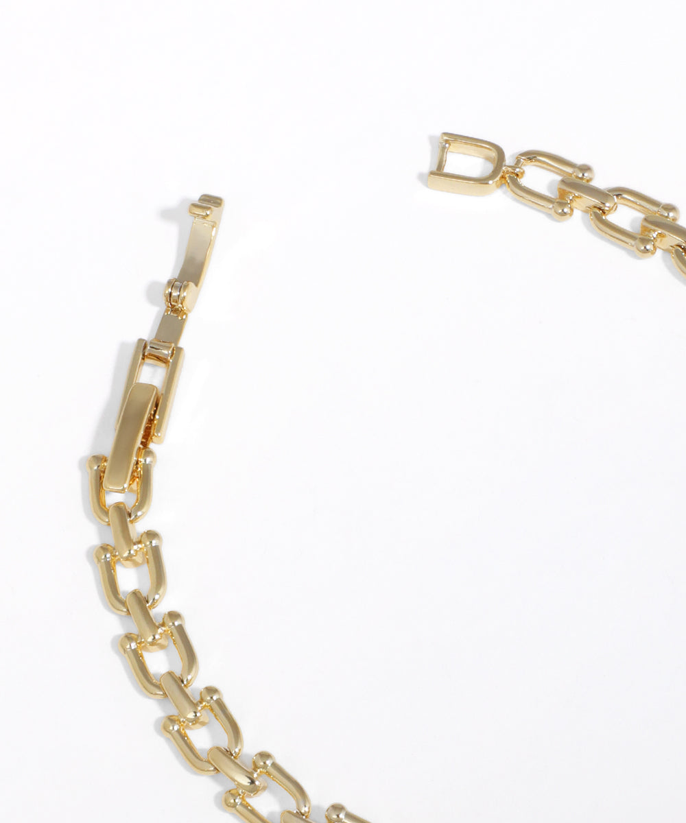 Gold chain bracelet on a white background