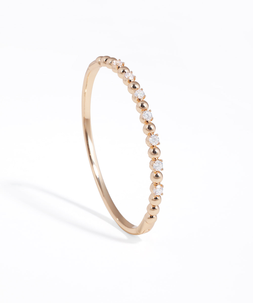 Rose gold ring with small diamonds on a white background