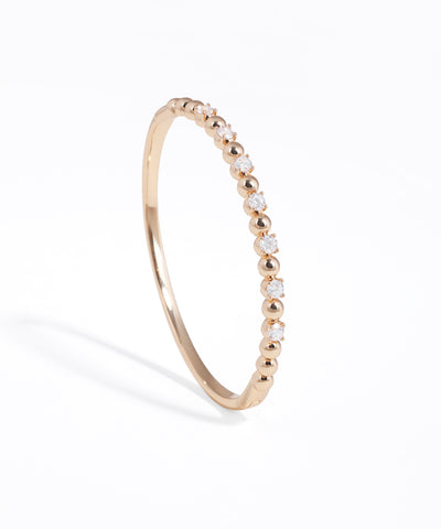 Rose gold ring with small diamonds on a white background
