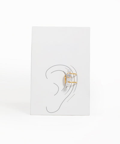 Earring display card with ear illustration and two earrings on a white background