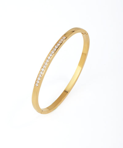 Gold bracelet with small diamonds on a white background