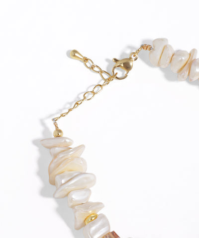 Bracelet with shell beads and gold chain on a white background