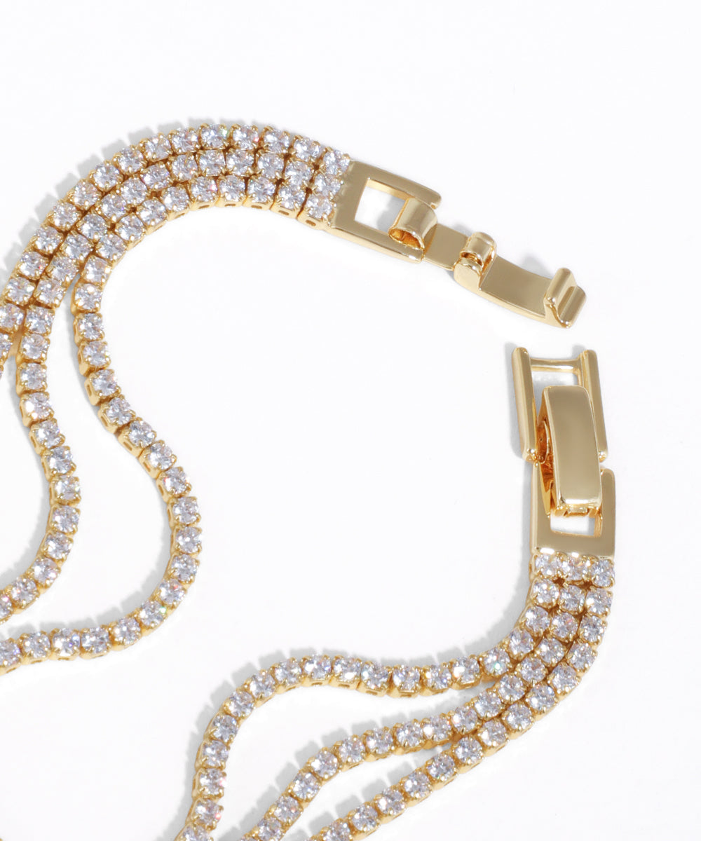 Gold chain with diamond-like stones on a white background